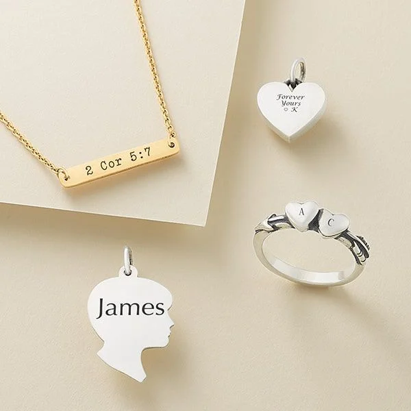 Engraved charms and necklaces in silver and gold