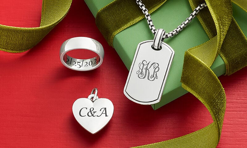 An engraved ring, charm, and pendant from James Avery.