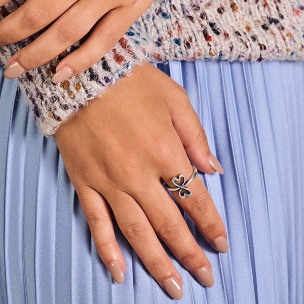 Woman wearing a sterling silver heart ring.