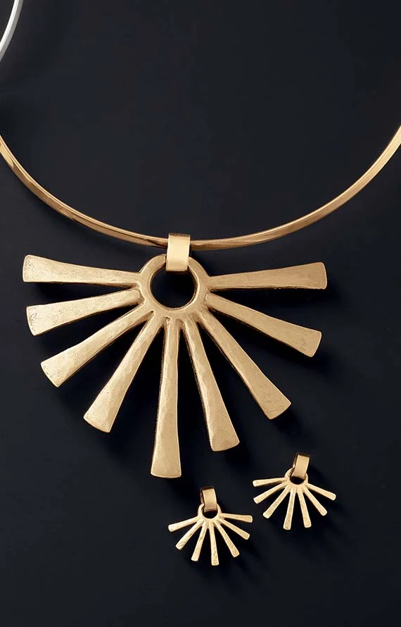 The Sunburst Pendant with Collet Neck Collar and Sunburst Ear Posts, shown in 14K gold on a black background