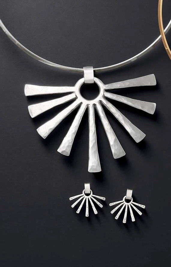 The Sunburst Pendant with Collet Neck Collar and Sunburst Ear Posts, shown in sterling silver on a black background