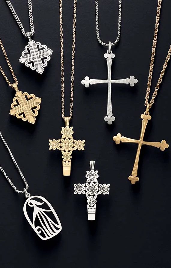 Cross-themed charms and pendants in sterling silver and 14K gold on a black background