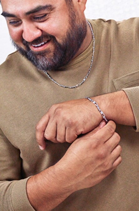 Man wearing a sterling silver bracelet and necklace.